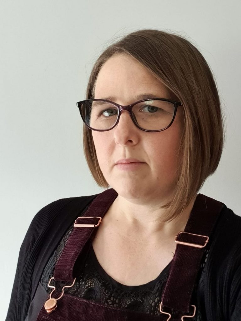 A head and shoulders shot of Gemma from Synergy Social looking at the camera.